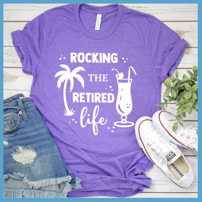 Rocking The Retired Life T-Shirt Heather Purple - Retirement-themed t-shirt with palm tree and drink design celebrating the leisure life.