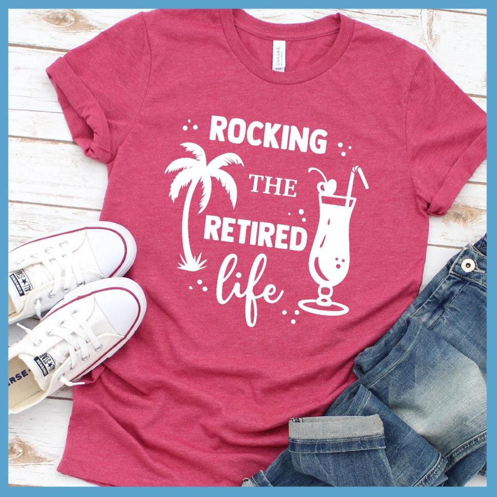 Rocking The Retired Life T-Shirt Heather Raspberry - Retirement-themed t-shirt with palm tree and drink design celebrating the leisure life.