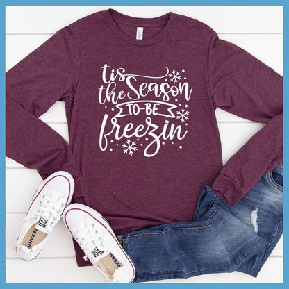 Tis The Season To Be Freezin Long Sleeves Maroon Triblend - Long sleeve winter shirt with whimsical snowflake design and festive phrase.