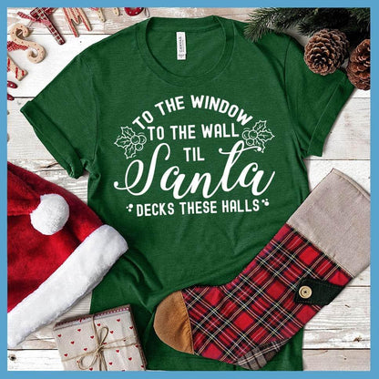 To The Window To the Wall Till Santa Decks These Halls T-Shirt Heather Grass Green - Holiday spirit t-shirt with fun Santa-themed graphic design perfect for Christmas celebrations.