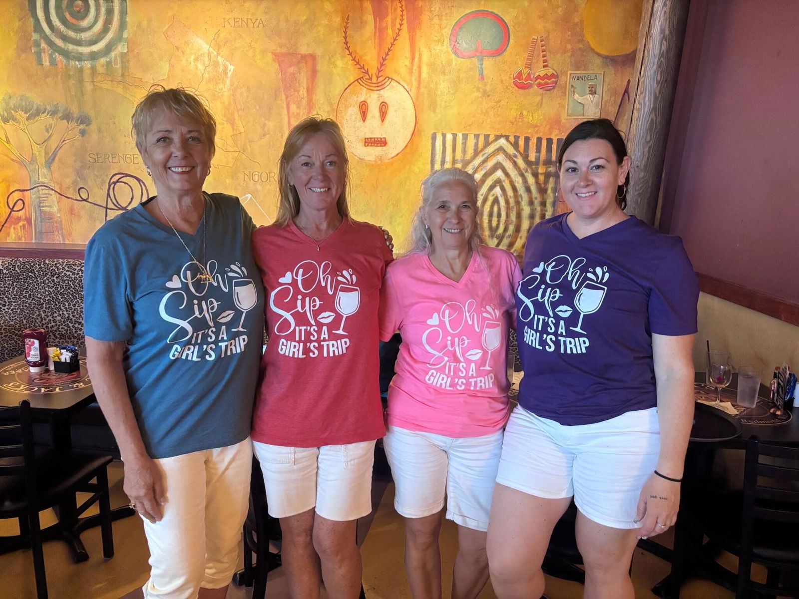 Friends wearing matching Brooke & Belle girls trip shirts