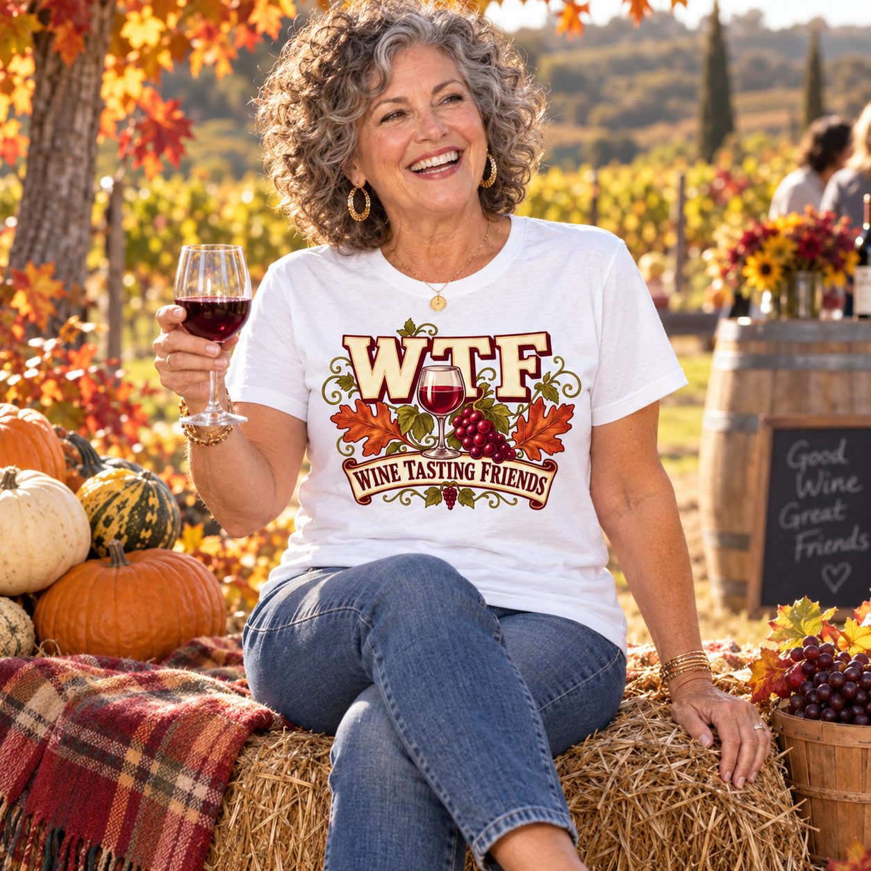 A friend on a hay bale beside pumpkins at a fall tasting in the white WTF shirt